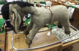 A Merrythought woodwool filled donkey on chrome rocking base