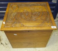 A 20th Century oak carved box decorated with a dragon in the Arts & Crafts taste