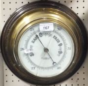 A brass cased ships barometer by John Barker & Co. Ltd.