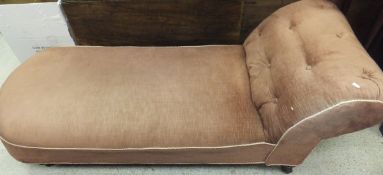 A Victorian chaise longue with salmon pink upholstery on ringed and turned supports to china