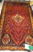 A modern Caucasian rug, the central diamond shaped medallion decorated in red,