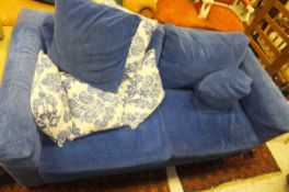 A modern two seat sofa bed upholstered in blue chenille type fabric