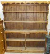 A waxed pine dresser of five open shelves with boarded backs