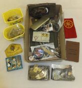 A box containing assorted military arm bands, badges,