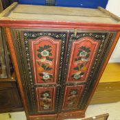 An Indian painted two door cupboard with two drawers