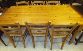 A pine rectangular kitchen table on turned legs,