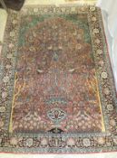 A Persian silk rug,