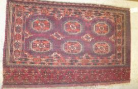 A Bokhara tribal rug, the six elephant foot medallions in red, burgundy,