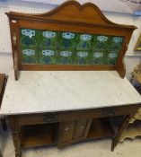 A walnut framed wash stand with marble top and tiled back on turned and ringed supports to castors