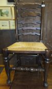 A set of five oak ladder back dining chairs with rush seats on turned supports and stretchers
