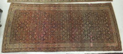 A Persian rug, the centre field with all-over floral, foliate and animal decoration in terracotta,