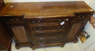 A reproduction mahogany breakfront sideboard with four central drawers flanked by a cupboard door