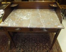 An Edwardian mahogany and inlaid marble top washstand with three quarter galleried top over two