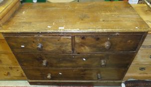 A late 19th Century stained pine chest of two short and two long drawers on a plinth base