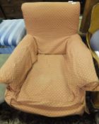 A Victorian armchair in loose peach self patterned covers