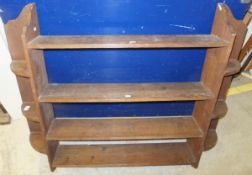 A circa 1900 oak four tier wall shelf in the Arts and Crafts taste