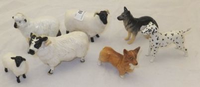 A collection of Beswick pottery animals to include four sheep, a German Shepherd (Alsatian) dog,