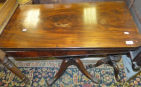 A Victorian mahogany fold-over card table on pedestal quartered base and scroll feet