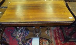 WITHDRAWN  An early Victorian rosewood foldover card table with beaded edge on a baluster turned