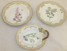 A pair of Royal Copenhagen porcelain plates with pierced decoration, each decorated with a wild