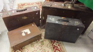 Four various leather suitcases,