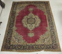 A Persian carpet, the central floral decorated medallion in cream, pale blue, dark blue,