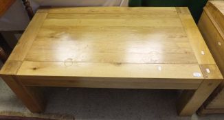 A modern oak rectangular coffee table on square legs