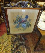 A Victorian rosewood pole screen, the beadwork panel with exotic bird amongst blossom,