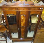 A Victorian walnut and stained beech double mirrored door wardrobe