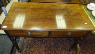 A mahogany side table with two drawers on turned and ringed supports