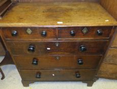 An early 19th Century North Country oak chest of two short and three long graduated drawers on