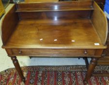 A mahogany wash stand with three quarter galleried top and long single top to frieze top