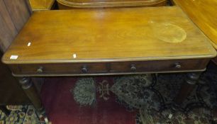 A Victorian mahogany two drawer side table on turned legs to castors