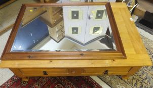 A modern pine coffee table, the plain top above two drawers,