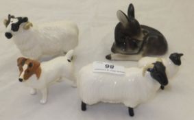 A collection of four Beswick pottery figures to include a Terrier and three sheep figures,