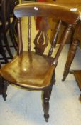 A matched set of eight elm seated kitchen chairs with turned legs and stretchered base,