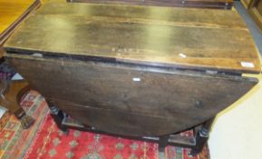 A 19th Century oak oval gate-leg drop-leaf dining table in the 17th Century manner