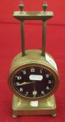 An early 20th Century brass cased gravity clock, stamped "British Make",