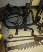 A 20th Century wrought iron fire basket with integral back, pair of fire dogs, two fire cranes,