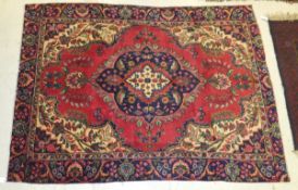 A European Persian design rug, the central medallion in cream, blue and red,