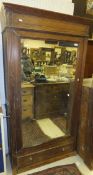 A Continental pitch pine mirrored wardrobe / cupboard