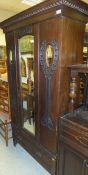An Edwardian mahogany single door wardrobe in the Art Nouveau taste with single drawer to base,