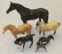A collection of Beswick pottery horses to include a large figure of a Stallion, a Palomino horse,