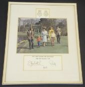 A framed and glazed image of the Royal Family walking in the grounds at Frogmore on the Windsor