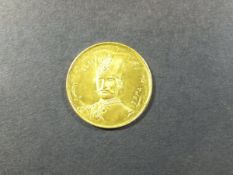 A Persian gold coin with moustached Shah in tall hat and with script verso CONDITION REPORTS Some