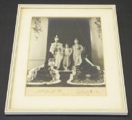 A framed and glazed photographic image of George VI and Queen Elizabeth with Princesses Elizabeth