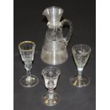 A late 19th Century glass jug with ribbed top and bottom sections and floral and bird engraving,