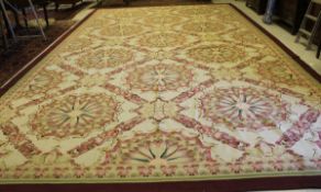 A large Aubusson type carpet, the centre field with stylised floral medallions in taupe, mushroom,