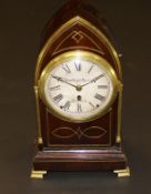 A 19th Century mahogany and brass inlaid mantel clock of lancet form, the movement with circular