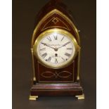 A 19th Century mahogany and brass inlaid mantel clock of lancet form, the movement with circular